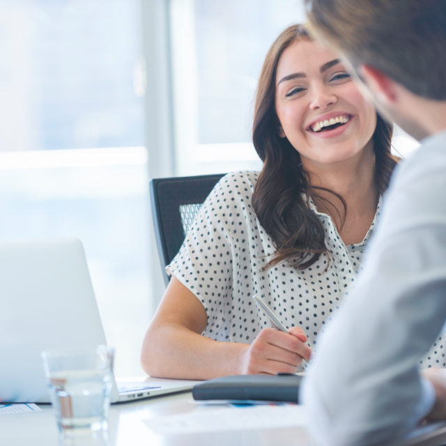 Woman sitting and laughing with a man