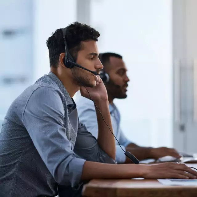 Two salesmen on headsets