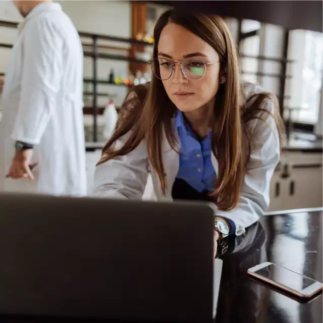 Woman using laptop in lab