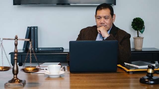 Lawyer in office looking at laptop