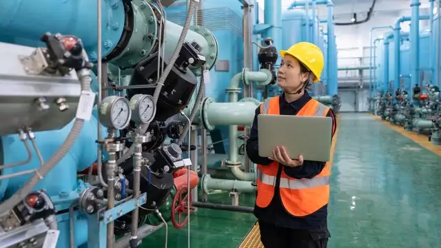 Manufacturing worker holding laptop