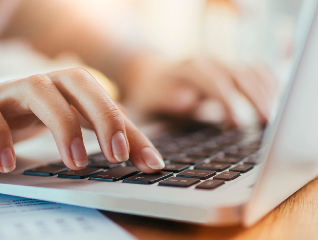 Close up of hands typing