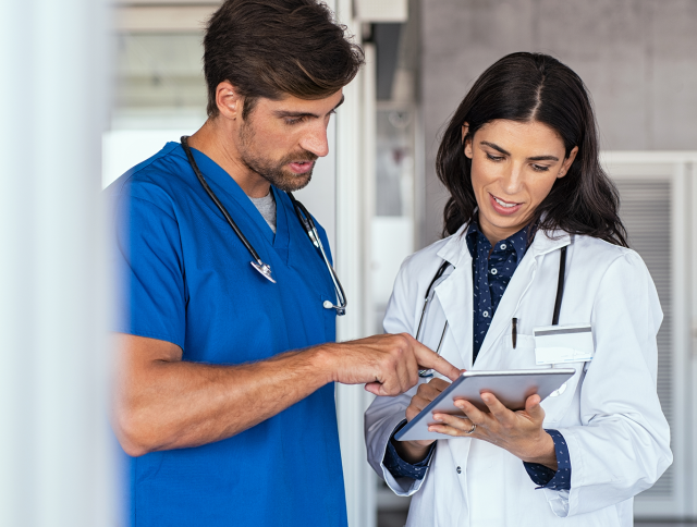 Two nurses looking at a tablet