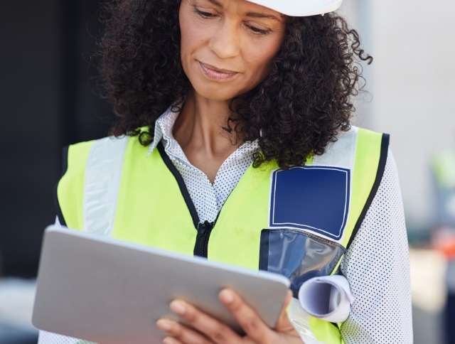 Construction woman looking at tablet