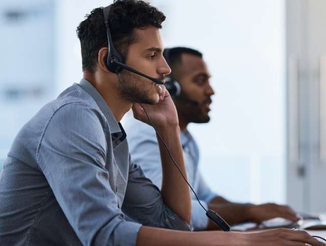 Two salesmen on headsets