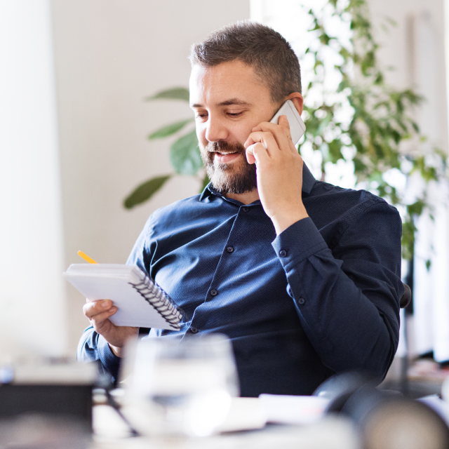 Man talking on phone about benefits of Conga's Commercial Operations Suite 