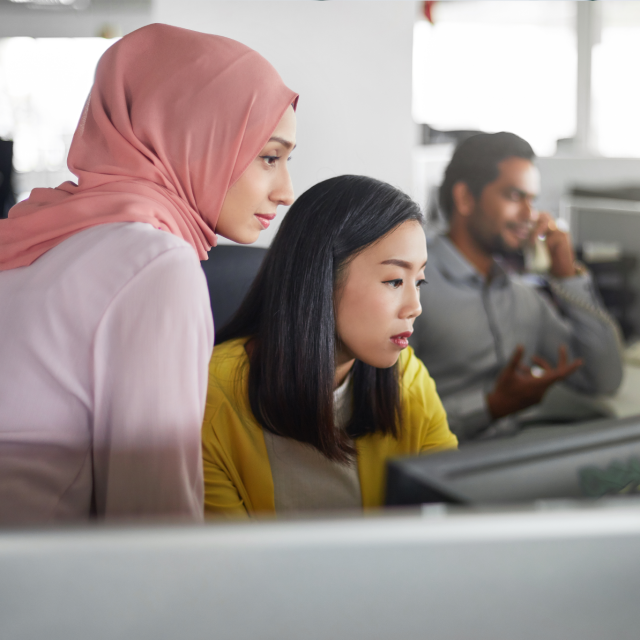 Two women looking at a computer screen