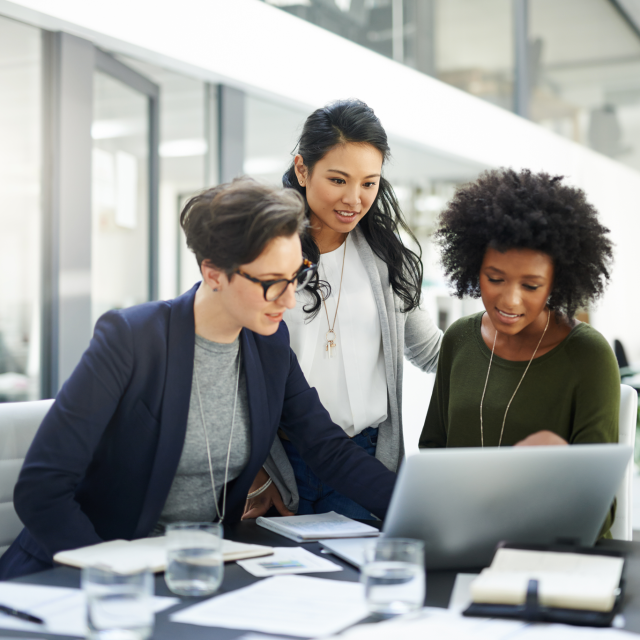 Group of women meeting and working on a laptop