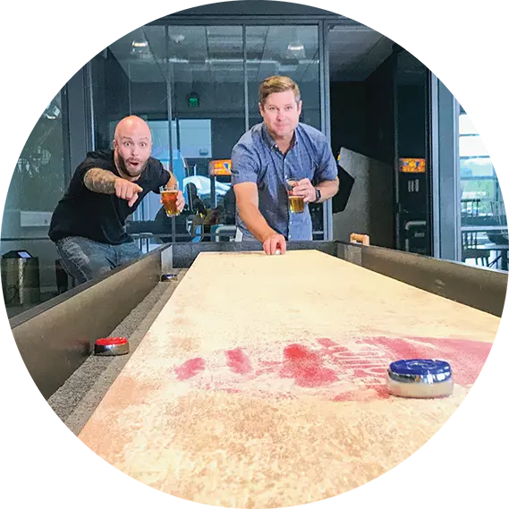 Conga employees playing shuffle board at the office