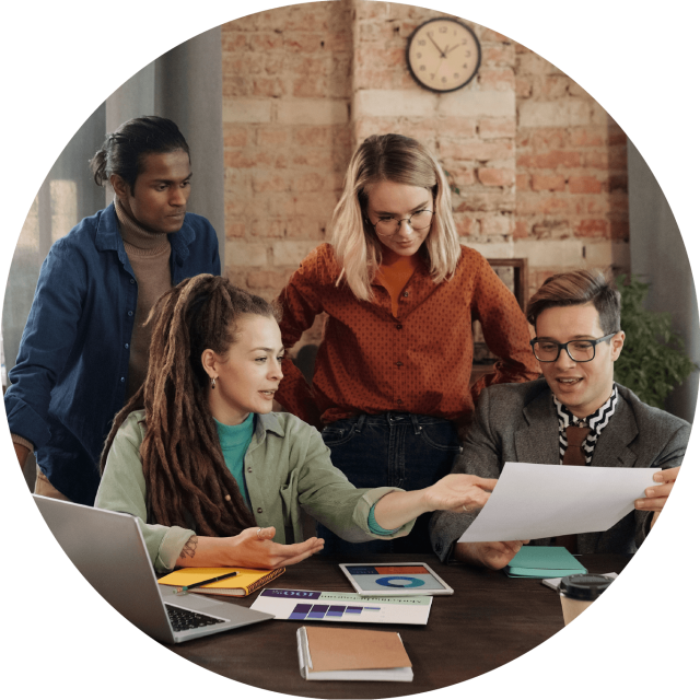 Four people looking over a document