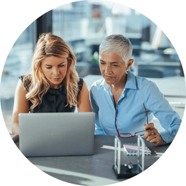 Two woman looking at laptop