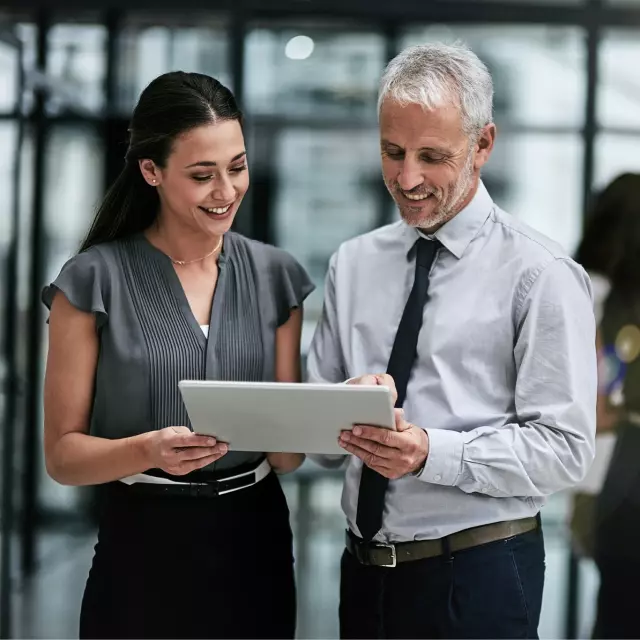 Man and woman looking at tablet