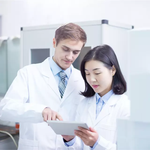 Lab technicians using Conga products on tablet