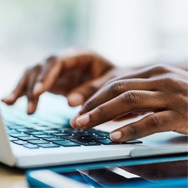 Fingers typing on keyboard