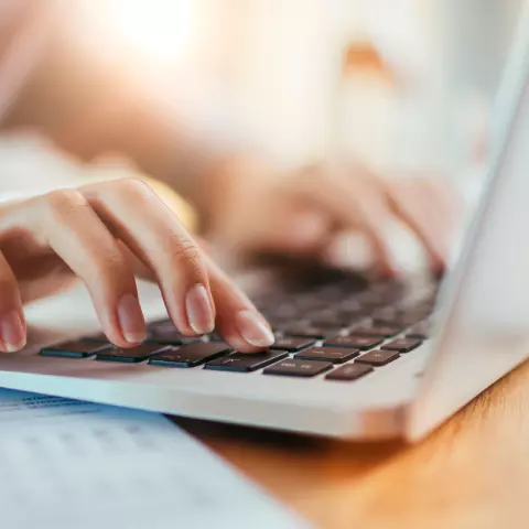 Close up of hands typing